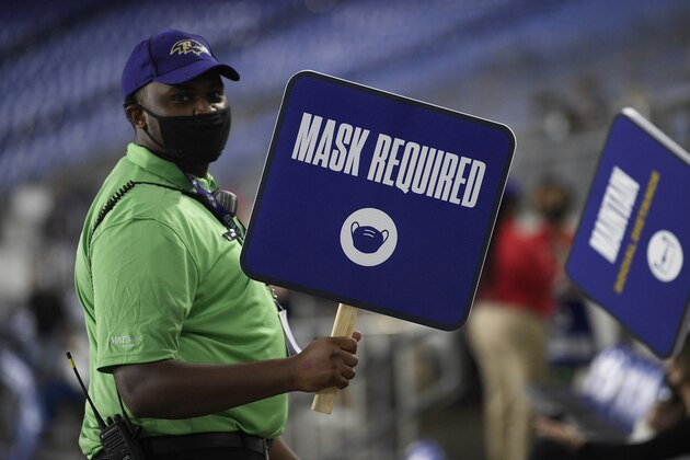 A sign indicating mask use is seen during an NFL football game between the Kansas City Chiefs and the Baltimore Ravens, Monday, Sept. 28, 2020, in Baltimore. (AP Photo/Nick Wass)