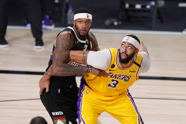 Denver Nuggets' Torrey Craig, left, and Los Angeles Lakers' Anthony Davis, right, battle during the second half of an NBA conference final playoff basketball game Thursday, Sept. 24, 2020, in Lake Buena Vista, Fla. (AP Photo/Mark J. Terrill)