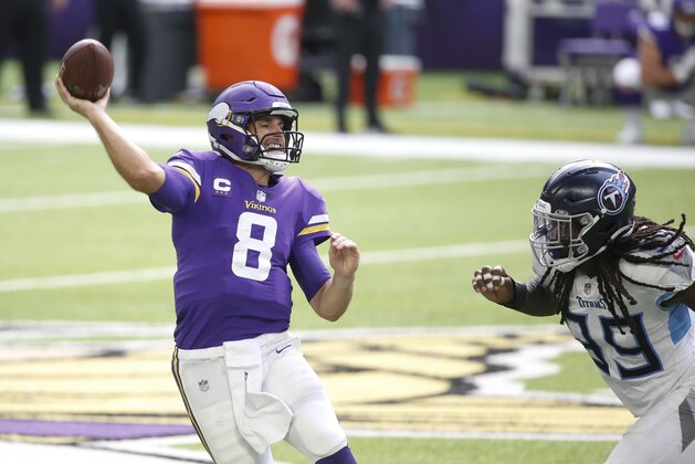 Minnesota Vikings quarterback Kirk Cousins (8) throws a pass over Tennessee Titans outside linebacker Jadeveon Clowney, right, during the second half of an NFL football game, Sunday, Sept. 27, 2020, in Minneapolis. (AP Photo/Bruce Kluckhohn)