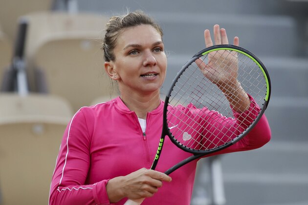 Romania's Simona Halep celebrates winning her second round match of the French Open tennis tournament against Romania's Irina-Camelia Begu at the Roland Garros stadium in Paris, France, Wednesday, Sept. 30, 2020. (AP Photo/Alessandra Tarantino)