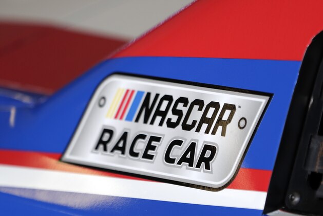 A NASCAR logo on a car is seen in the garage during a NASCAR auto racing practice session at Daytona International Speedway, Saturday, Feb. 10, 2018, in Daytona Beach, Fla. (AP Photo/John Raoux)