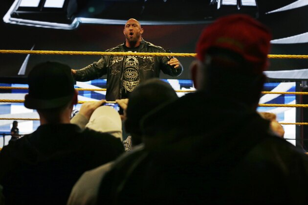 People gather ringside as they listen to professional wrestler Ryan Reeves, known as Ryback, at the Wrestlemania Axxess event Saturday, April 6, 2013, in East Rutherford, N.J., ahead of Sunday's WWE Wrestlemania 29 at MetLife stadium. (AP Photo/Mel Evans)