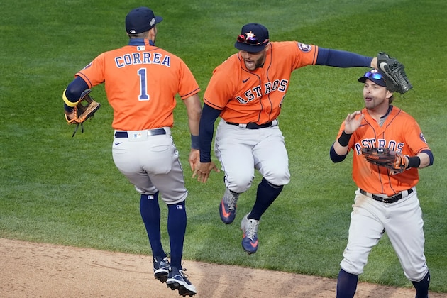 Houston Astros' Carlos Correa, left, and George Springer, center, jump in celebration of the Astros 4-1 win over the Minnesota Twins 4-1 in Game 1 of an American League wild-card baseball series, Tuesday Sept. 29, 2020, in Minneapolis. At right is Josh Reddick. (AP Photo/Jim Mone) Houston Astros' Carlos Correa, left, and George Springer, center, jump in celebration of the Astros 4-1 win over the Minnesota Twins 4-1 in Game 1 of an American League wild-card baseball series, Tuesday Sept. 29, 2020, in Minneapolis. At right is Josh Reddick. (AP Photo/Jim Mone)
