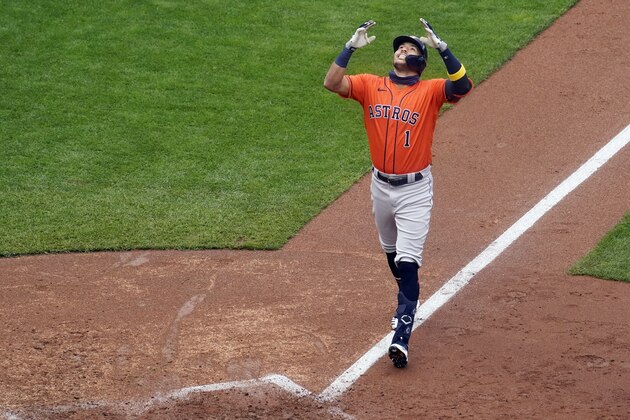 Houston Astros' Carlos Correa celebrates his go-ahead solo home run off Minnesota Twins relief pitcher Cody Stashak in the seventh inning  in Game 2 to clinch the American League wild-card baseball series, Wednesday, Sept. 30, 2020, in Minneapolis. The Astros won 3-1 to win the three-game series. (AP Photo/Jim Mone)