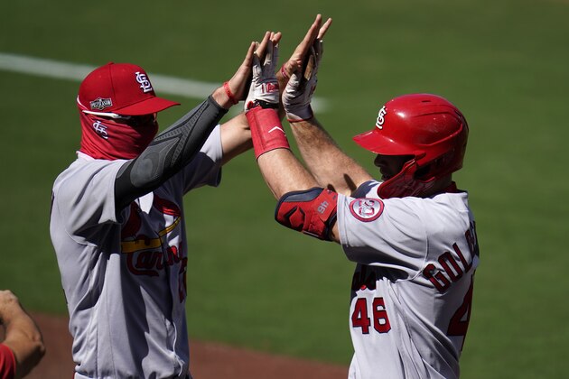 St. Louis Cardinals' Paul Goldschmidt, right, reacts with teammate Jack Flaherty after hitting a two-run home run against the San Diego Padres during the first inning in Game 1 of a National League wild-card baseball series, Wednesday, Sept. 30, 2020, in San Diego. (AP Photo/Gregory Bull)