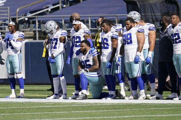 Dallas Cowboys defensive tackle Dontari Poe kneels as teammates stand during the national anthem before an NFL football game against the Seattle Seahawks, Sunday, Sept. 27, 2020, in Seattle. (AP Photo/Elaine Thompson)
