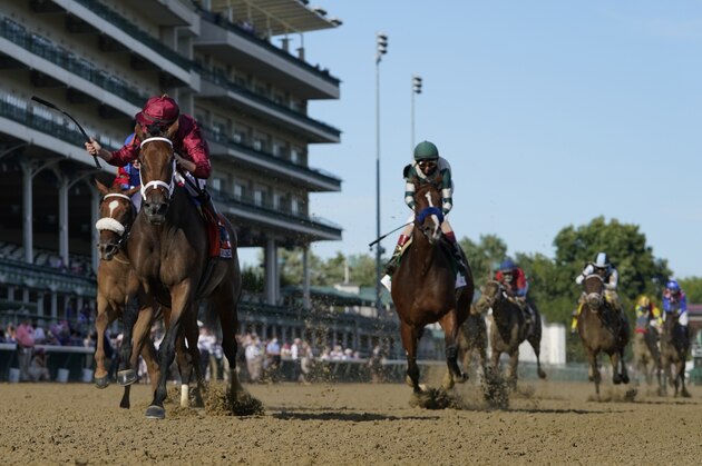 Florent Geroux riding Shedaresthedevil crosses the finish line ahead of Tyler Gaffalione on Swiss Skydiver, left and John Velazquez riding Gamine to win the 146th running of the Kentucky Oaks at Churchill Downs, Friday, Sept. 4, 2020, in Louisville, Ky. (AP Photo/Jeff Roberson)