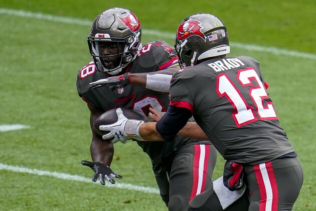 Tampa Bay Buccaneers quarterback Tom Brady (12) hands off to running back Leonard Fournette (28) against the Denver Broncos during an NFL football game, Sunday, Sept. 27, 2020, in Denver. (AP Photo/Jack Dempsey)