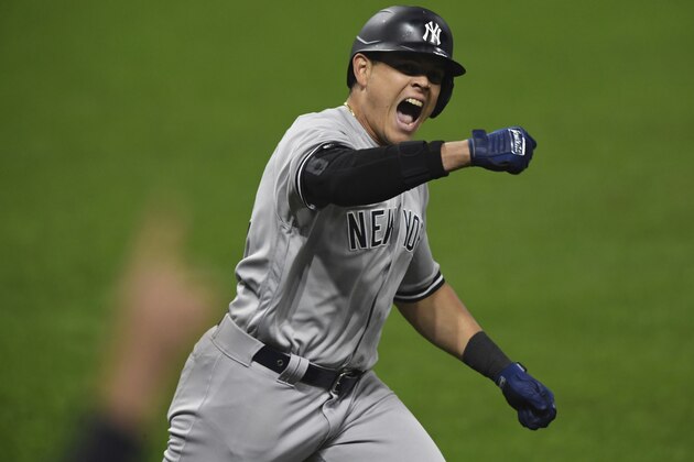 New York Yankees' Gio Urshela celebrates while running the bases after hitting a grand slam off Cleveland Indians relief pitcher James Karinchak in the fourth inning of Game 2 of an American League wild-card baseball series Wednesday, Sept. 30, 2020, in Cleveland. (AP Photo/David Dermer)