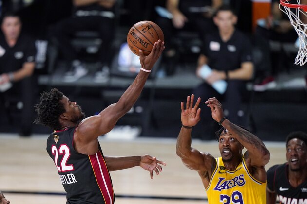 Miami Heat's Jimmy Butler (22) drives to the basket against Los Angeles Lakers' Dwight Howard (39) during the first half of Game 1 of basketball's NBA Finals Wednesday, Sept. 30, 2020, in Lake Buena Vista, Fla. (AP Photo/Mark J. Terrill) Miami Heat's Jimmy Butler (22) drives to the basket against Los Angeles Lakers' Dwight Howard (39) during the first half of Game 1 of basketball's NBA Finals Wednesday, Sept. 30, 2020, in Lake Buena Vista, Fla. (AP Photo/Mark J. Terrill)
