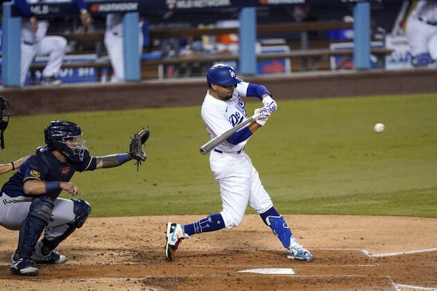 Los Angeles Dodgers' Mookie Betts connects for an RBI double during the second inning in Game 1 of the etam's National League wild-card baseball series against the Milwaukee Brewers on Wednesday, Sept. 30, 2020, in Los Angeles. (AP Photo/Ashley Landis) Los Angeles Dodgers' Mookie Betts connects for an RBI double during the second inning in Game 1 of the etam's National League wild-card baseball series against the Milwaukee Brewers on Wednesday, Sept. 30, 2020, in Los Angeles. (AP Photo/Ashley Landis)