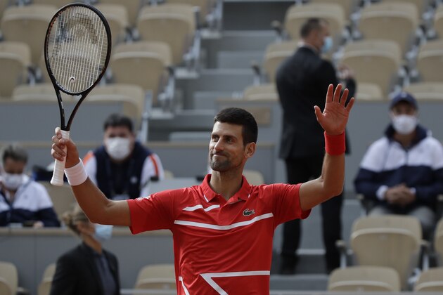Serbia's Novak Djokovic celebrates winning his second round match of the French Open tennis tournament against Lithuania's Ricardas Berankis at the Roland Garros stadium in Paris, France, Thursday, Oct. 1, 2020. (AP Photo/Alessandra Tarantino)