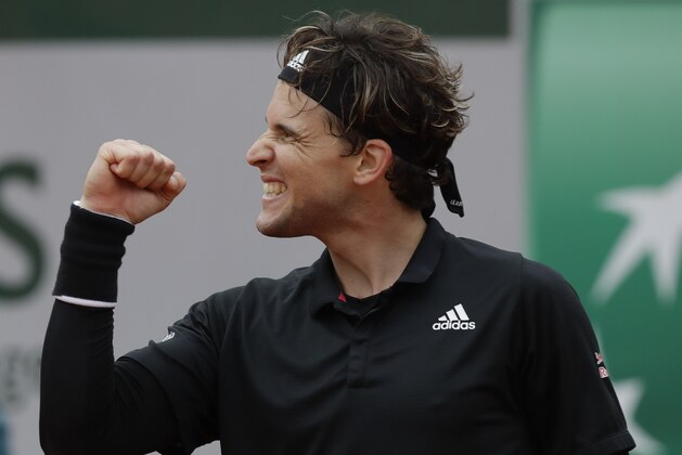 Austria's Dominic Thiem celebrates winning his second round match of the French Open tennis tournament against Jack Sock of the U.S. at the Roland Garros stadium in Paris, France, Wednesday, Sept. 30, 2020. (AP Photo/Alessandra Tarantino)