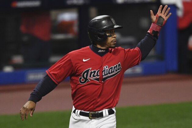 Cleveland Indians' Francisco Lindor scores a run on a two RBI double by Jose Ramirez in the fifth inning of Game 2 of an American League wild-card baseball series against the New York Yankees, Wednesday, Sept. 30, 2020, in Cleveland. (AP Photo/David Dermer)