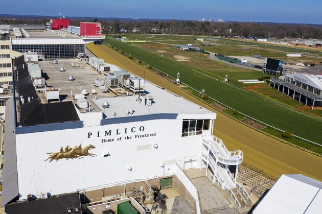 FILE - In this March 26, 2020, file photo, tractors groom the racing surface at the Pimlico Race Track in Baltimore, Md. The Preakness will remain at Pimlico Race Course into the foreseeable future, thanks to the passing of a bill to redevelop Maryland's race tracks with $375 million in bonds. (AP Photo/Steve Helber, File) FILE - In this March 26, 2020, file photo, tractors groom the racing surface at the Pimlico Race Track in Baltimore, Md. The Preakness will remain at Pimlico Race Course into the foreseeable future, thanks to the passing of a bill to redevelop Maryland's race tracks with $375 million in bonds. (AP Photo/Steve Helber, File)