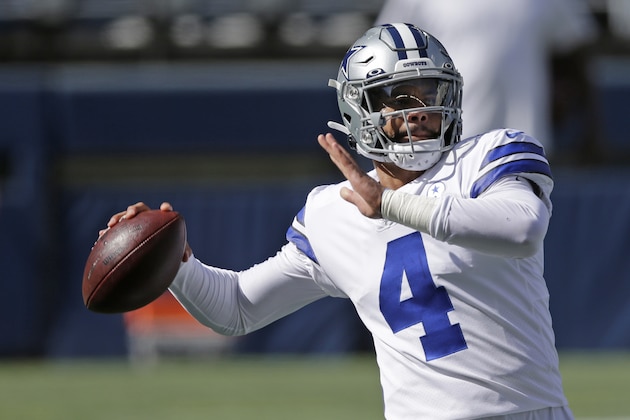 Dallas Cowboys quarterback Dak Prescott passes during warmups before an NFL football game against the Seattle Seahawks, Sunday, Sept. 27, 2020, in Seattle. (AP Photo/John Froschauer)