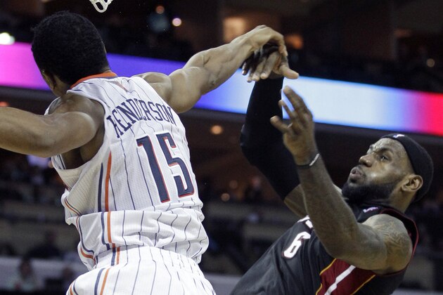 Miami Heat's LeBron James (6) has his shot blocked by Charlotte Bobcats' Gerald Henderson (15) during the second half of the Heat's 96-95 win in an NBA basketball game in Charlotte, N.C., Wednesday, Dec. 28, 2011. (AP Photo/Chuck Burton)