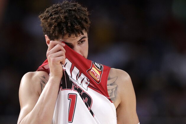 LaMelo Ball of the Illawarra Hawks wipes his face during their game against the Sydney Kings in the Australian Basketball League in Sydney, Sunday, Nov. 17, 2019. (AP Photo/Rick Rycroft)