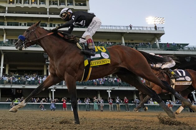 Jockey John Velazquez riding Authentic, right, crosses the finish line to win the 146th running of the Kentucky Derby at Churchill Downs, Saturday, Sept. 5, 2020, in Louisville, Ky. (AP Photo/Jeff Roberson)