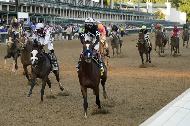 Jockey John Velazquez riding Authentic (18) crosses the finish line to win the 146th running of the Kentucky Derby at Churchill Downs, Saturday, Sept. 5, 2020, in Louisville, Ky. (AP Photo/Jeff Roberson)