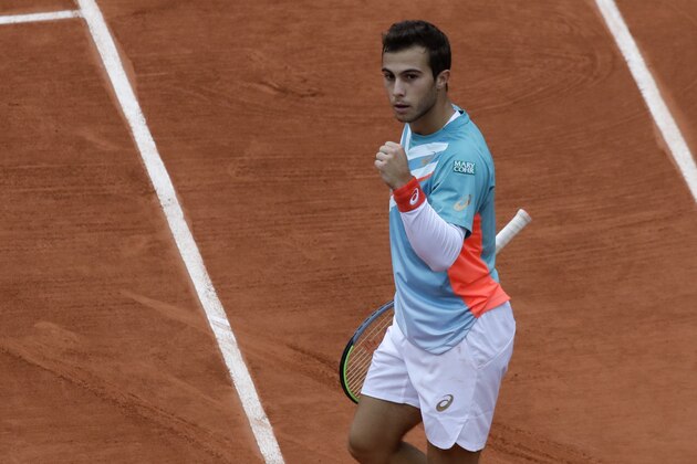 France's Hugo Gaston clenches his fist after scoring a point against Switzerland's Stan Wawrinka in the third round match of the French Open tennis tournament at the Roland Garros stadium in Paris, France, Friday, Oct. 2, 2020. (AP Photo/Alessandra Tarantino)