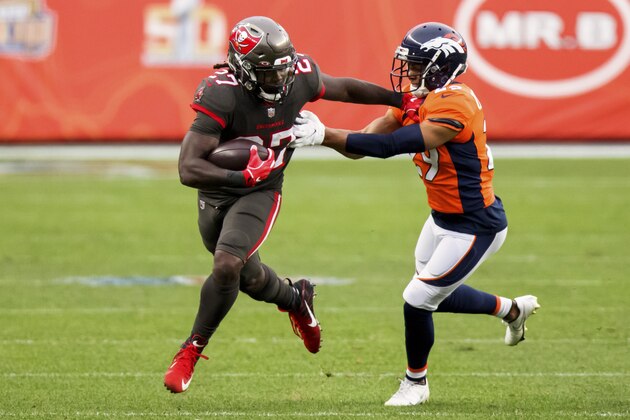 Tampa Bay Buccaneers running back Ronald Jones II (27) uses a stiff arm to elude Denver Broncos cornerback Bryce Callahan (29) in the second half of an NFL football game, Sunday, Sept.. 27, 2020, in Denver. (AP Photo/Justin Edmonds) Tampa Bay Buccaneers running back Ronald Jones II (27) uses a stiff arm to elude Denver Broncos cornerback Bryce Callahan (29) in the second half of an NFL football game, Sunday, Sept.. 27, 2020, in Denver. (AP Photo/Justin Edmonds)