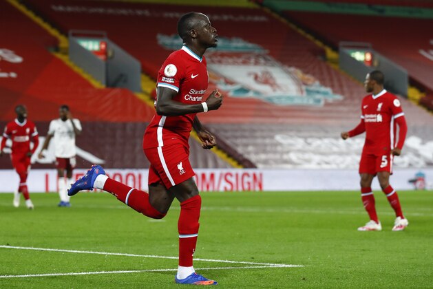 Liverpool's Sadio Mane celebrates after scoring his team's first goal during the English Premier League soccer match between Liverpool and Arsenal at Anfield in Liverpool, England, Monday, Sept. 28, 2020. (Jason Cairnduff/Pool via AP)