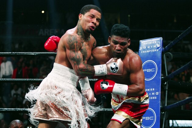 CORRECTS DATE - Gervonta Davis, left, lands a punch on Yuriorkis Gamboa during round six for the WBA lightweight boxing bout Sunday, Dec. 29, 2019, in Atlanta. Davis won the title by a 12th round TKO. (AP Photo/Tami Chappell)
