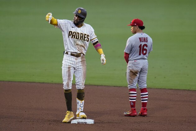 San Diego Padres' Fernando Tatis Jr., left, reacts after hitting a double, next to St. Louis Cardinals second baseman Kolten Wong during the fifth inning of Game 3 of a National League wild-card baseball series Friday, Oct. 2, 2020, in San Diego. (AP Photo/Gregory Bull)