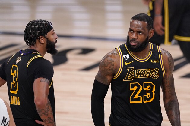 Los Angeles Lakers' Anthony Davis (3) and LeBron James (23) talk on the floor during the second half of Game 2 of basketball's NBA Finals, Friday, Oct. 2, 2020, in Lake Buena Vista, Fla. (AP Photo/Mark J. Terrill)