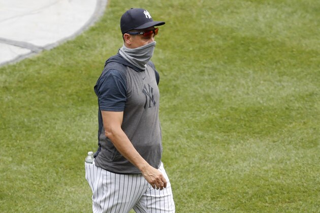 New York Yankees manager Aaron Boone wears a neck gaiter as a mask during a baseball summer training camp workout at Yankee Stadium, Wednesday, July 8, 2020, in New York. (AP Photo/Kathy Willens)