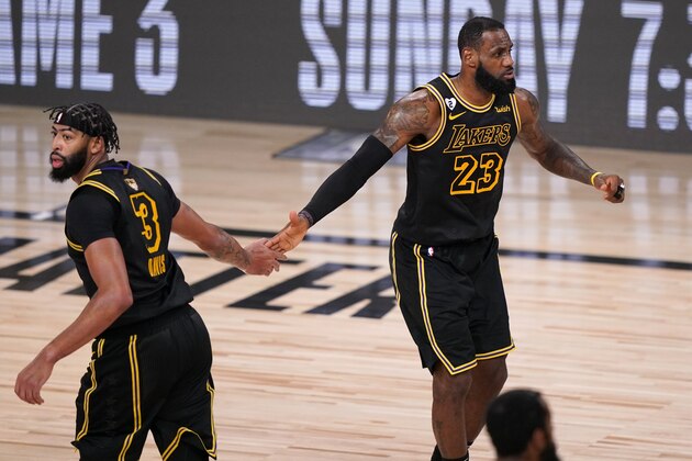 Los Angeles Lakers' Anthony Davis (3) and LeBron James (23) celebrate a basket against the Miami Heat during the second half of Game 2 of basketball's NBA Finals, Friday, Oct. 2, 2020, in Lake Buena Vista, Fla. (AP Photo/Mark J. Terrill)