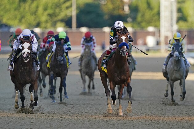 Jockey John Velazquez rides Authentic, second from right, as they cross the finish line to win the 146th running of the Kentucky Derby at Churchill Downs, Saturday, Sept. 5, 2020, in Louisville, Ky. (AP Photo/Mark Humphrey)