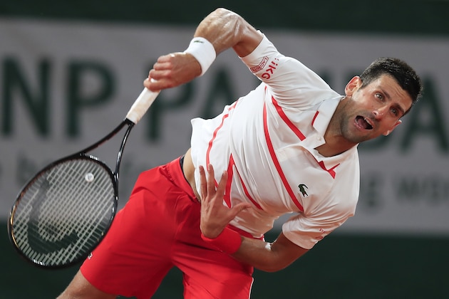 Serbia's Novak Djokovic serves against Sweden's Mikael Ymer in the first round match of the French Open tennis tournament at the Roland Garros stadium in Paris, France, Tuesday, Sept. 29, 2020. (AP Photo/Michel Euler) Serbia's Novak Djokovic serves against Sweden's Mikael Ymer in the first round match of the French Open tennis tournament at the Roland Garros stadium in Paris, France, Tuesday, Sept. 29, 2020. (AP Photo/Michel Euler)