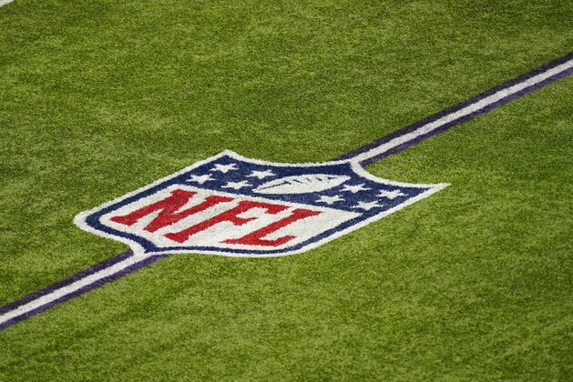 The NFL logo is seen on the field in U.S. Bank Stadium before an NFL football game between the Minnesota Vikings and the Tennessee Titans, Sunday, Sept. 27, 2020, in Minneapolis. (AP Photo/Charlie Neibergall) The NFL logo is seen on the field in U.S. Bank Stadium before an NFL football game between the Minnesota Vikings and the Tennessee Titans, Sunday, Sept. 27, 2020, in Minneapolis. (AP Photo/Charlie Neibergall)