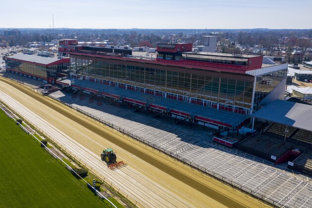 Tractors groom the racing surface at the Pimlico Race Track Thursday March 26, 2020, in Baltimore, Md. The Preakness horse race is scheduled for the track May 14-16. Officials have not made any determination as to any delay due to the coronavirus outbreak. (AP Photo/Steve Helber)