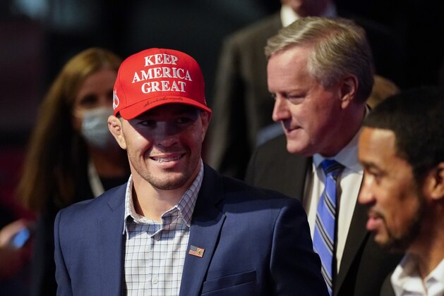 UFC fighter Colby Covington, left, and White Chief of Staff Mark Meadows, right, arriving at the first presidential debate Tuesday, Sept. 29, 2020, at Case Western University and Cleveland Clinic, in Cleveland, Ohio. (AP Photo/Julio Cortez)