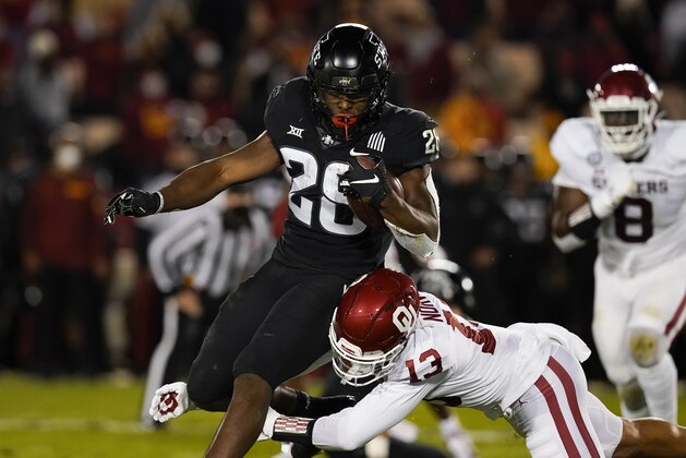 Iowa State running back Breece Hall (28) breaks a tackle by Oklahoma defensive back Tre Norwood (13) during the first half an NCAA college football game, Saturday, Oct. 3, 2020, in Ames, Iowa. (AP Photo/Charlie Neibergall) Iowa State running back Breece Hall (28) breaks a tackle by Oklahoma defensive back Tre Norwood (13) during the first half an NCAA college football game, Saturday, Oct. 3, 2020, in Ames, Iowa. (AP Photo/Charlie Neibergall)