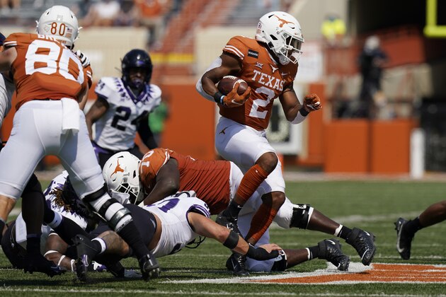 Texas running back Roschon Johnson (2) runs against TCU during the second half of an NCAA college football game, Saturday, Oct. 3, 2020, in Austin, Texas. (AP Photo/Eric Gay)
