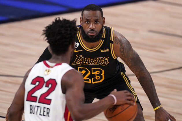 Los Angeles Lakers' LeBron James (23) defends as Miami Heat's Jimmy Butler (22) handles the ball during the second half of Game 2 of basketball's NBA Finals, Friday, Oct. 2, 2020, in Lake Buena Vista, Fla. (AP Photo/Mark J. Terrill) Los Angeles Lakers' LeBron James (23) defends as Miami Heat's Jimmy Butler (22) handles the ball during the second half of Game 2 of basketball's NBA Finals, Friday, Oct. 2, 2020, in Lake Buena Vista, Fla. (AP Photo/Mark J. Terrill)