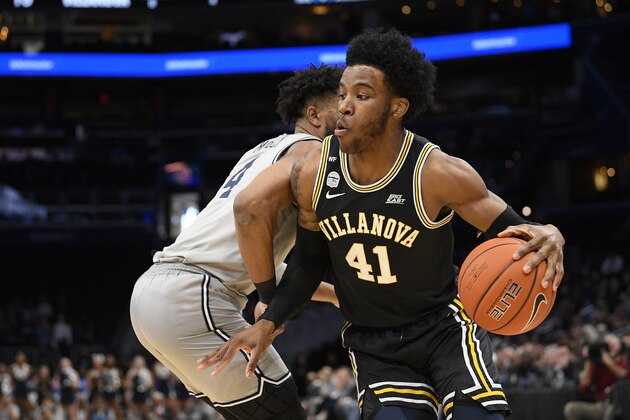 Villanova forward Saddiq Bey (41) dribbles the ball against Georgetown guard Jagan Mosely (4) during the first half of an NCAA college basketball game, Saturday, March 7, 2020, in Washington. (AP Photo/Nick Wass)