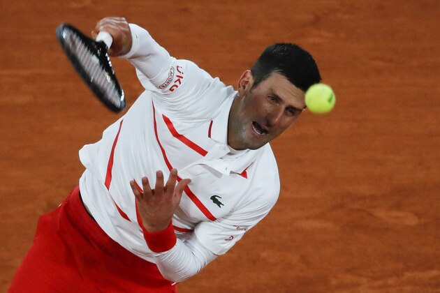 Serbia's Novak Djokovic serves against Colombia's Daniel Elahi Galan in the third round match of the French Open tennis tournament at the Roland Garros stadium in Paris, France, Saturday, Oct. 3, 2020. (AP Photo/Christophe Ena)