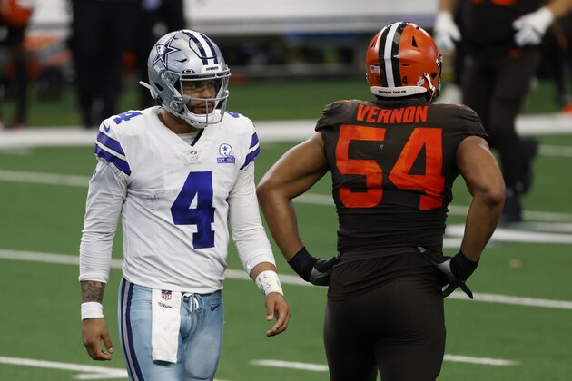 Dallas Cowboys quarterback Dak Prescott (4) walks past Cleveland Browns defensive end Olivier Vernon (54) on his way to the sideline after throwing an interception late in the second half of an NFL football game in Arlington, Texas, Sunday, Oct. 4, 2020. (AP Photo/Ron Jenkins) Dallas Cowboys quarterback Dak Prescott (4) walks past Cleveland Browns defensive end Olivier Vernon (54) on his way to the sideline after throwing an interception late in the second half of an NFL football game in Arlington, Texas, Sunday, Oct. 4, 2020. (AP Photo/Ron Jenkins)