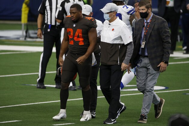 Cleveland Browns running back Nick Chubb (24) is assisted off the field by staff after suffering an unknown injury in the first half of an NFL football game against the Dallas Cowboys in Arlington, Texas, Sunday, Oct. 4, 2020. (AP Photo/Michael Ainsworth)