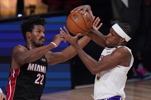 Los Angeles Lakers' Rajon Rondo (9) and Miami Heat's Jimmy Butler (22) fight for control fo the ball during the first half in Game 3 of basketball's NBA Finals, Sunday, Oct. 4, 2020, in Lake Buena Vista, Fla. (AP Photo/Mark J. Terrill)