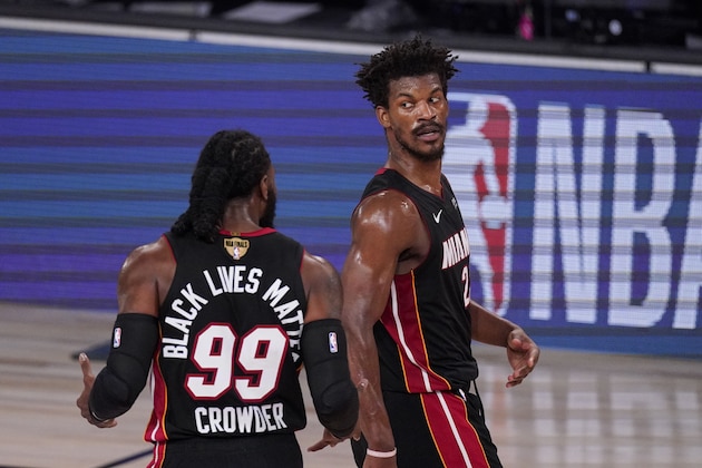 Miami Heat's Jimmy Butler (22) and Miami Heat's Jae Crowder (99) talk between plays during the first half in Game 3 of basketball's NBA Finals against the Los Angeles Lakers, Sunday, Oct. 4, 2020, in Lake Buena Vista, Fla. (AP Photo/Mark J. Terrill)