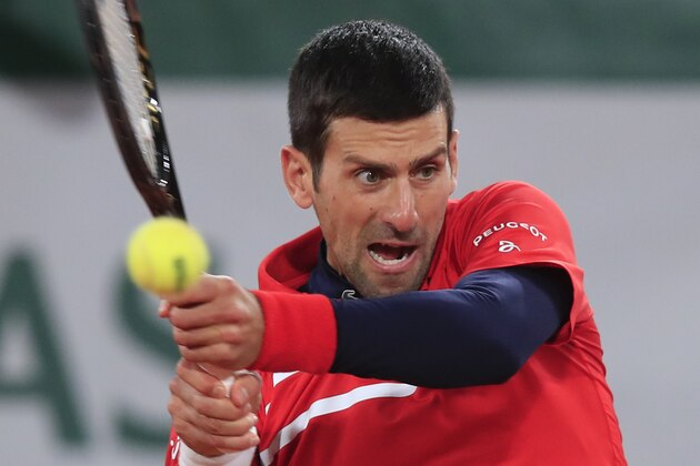 Serbia's Novak Djokovic plays a shot against Russia's Karen Khachanov in the fourth round match of the French Open tennis tournament at the Roland Garros stadium in Paris, France, Monday, Oct. 5, 2020. (AP Photo/Michel Euler) Serbia's Novak Djokovic plays a shot against Russia's Karen Khachanov in the fourth round match of the French Open tennis tournament at the Roland Garros stadium in Paris, France, Monday, Oct. 5, 2020. (AP Photo/Michel Euler)