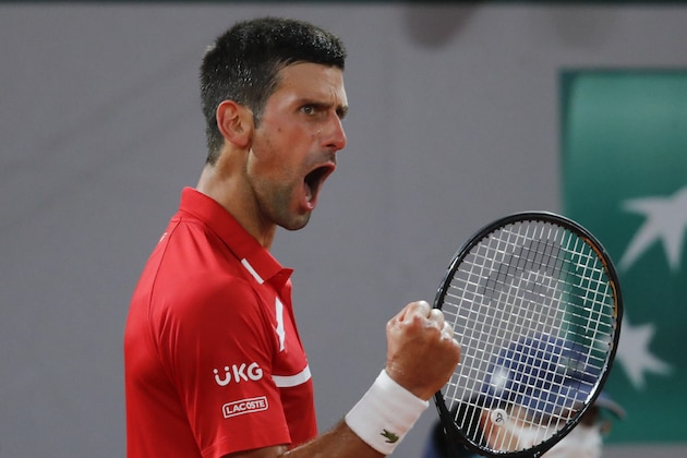 Serbia's Novak Djokovic clenches his fist after scoring a point against Russia's Karen Khachanov in the fourth round match of the French Open tennis tournament at the Roland Garros stadium in Paris, France, Monday, Oct. 5, 2020. (AP Photo/Christophe Ena)