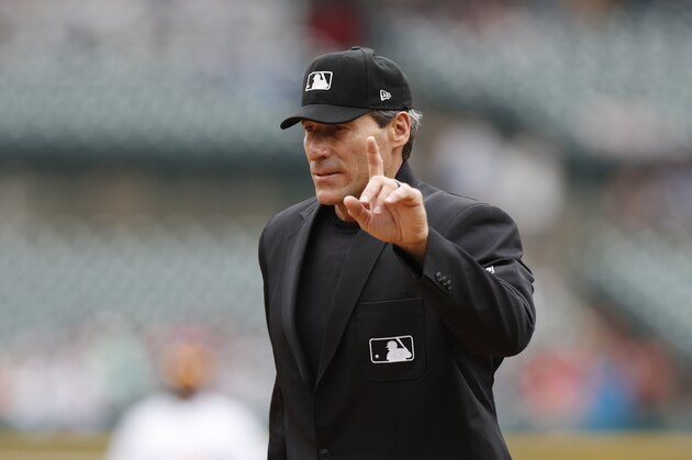 Home plate umpire Angel Hernandez signals during the fifth inning of a baseball game between the Detroit Tigers and the Minnesota Twins, Sunday, Sept. 1, 2019, in Detroit. (AP Photo/Carlos Osorio)