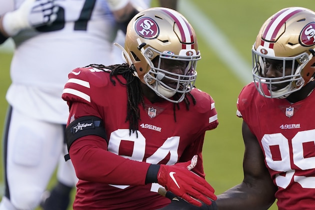 San Francisco 49ers defensive end Ezekiel Ansah, left, shakes hands with defensive tackle Javon Kinlaw during the first half of an NFL football game against the Philadelphia Eagles in Santa Clara, Calif., Sunday, Oct. 4, 2020. (AP Photo/Tony Avelar) San Francisco 49ers defensive end Ezekiel Ansah, left, shakes hands with defensive tackle Javon Kinlaw during the first half of an NFL football game against the Philadelphia Eagles in Santa Clara, Calif., Sunday, Oct. 4, 2020. (AP Photo/Tony Avelar)